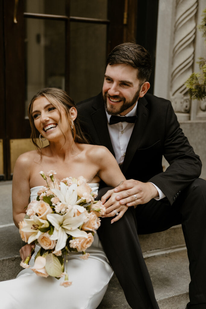 city elopement portrait of bride and groom laughing together and smiling