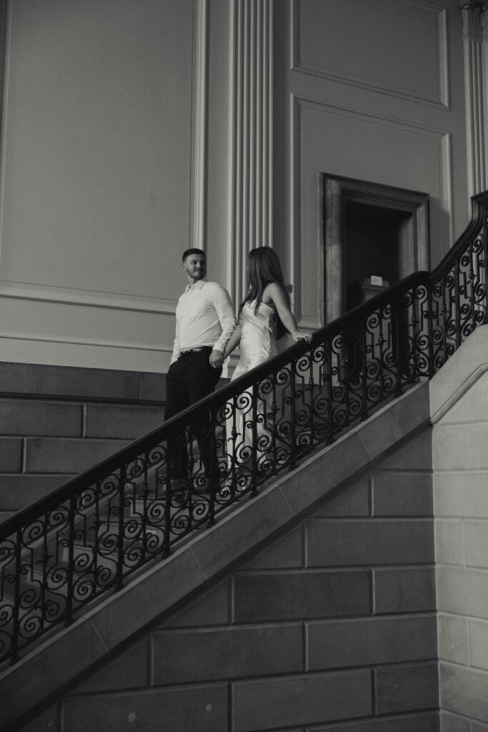 engagement session at VMFA of couple holding hands walking down the stairs together 