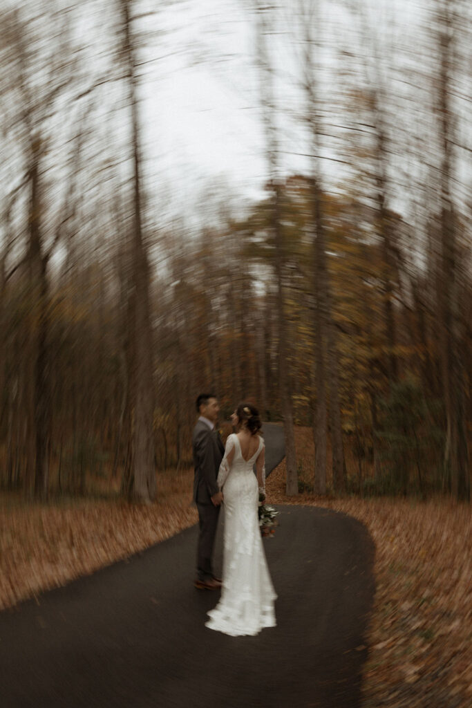 bride and groom surrounded by fall foilage at their wedding at Avonlea Farsm