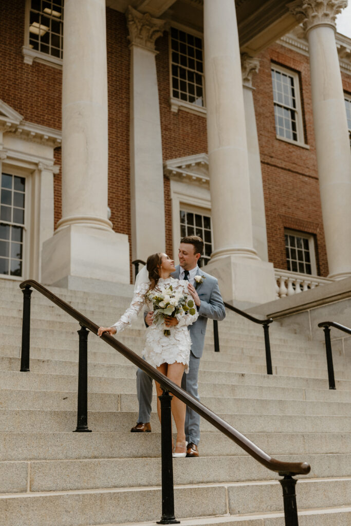 city elopement of couple on the stairs smiling at eachtoher