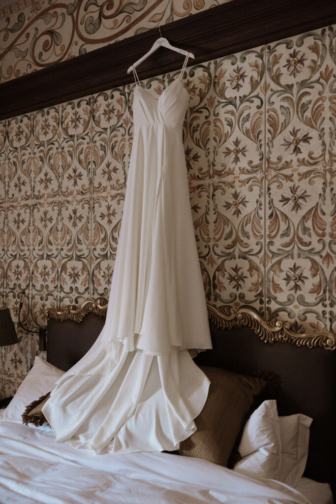 destination wedding in peru with the wedding dress hanging from the hotel room